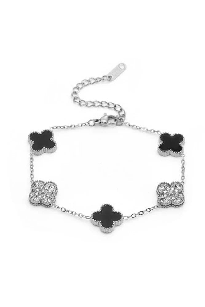 The Susan Rose Stainless Steel Clover CZ Bracelet - Silver/Blk features alternating black and cubic zirconia clover charms on a fine adjustable chain—a chic, versatile accessory for any occasion.