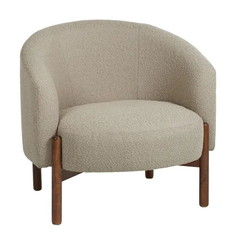 The Bianca Boucle Arm Chair by Coast to Coast features a curved backrest, armrests, light beige textured upholstery, and four warm brown wooden legs—perfect for adding an elegant touch to any living space.